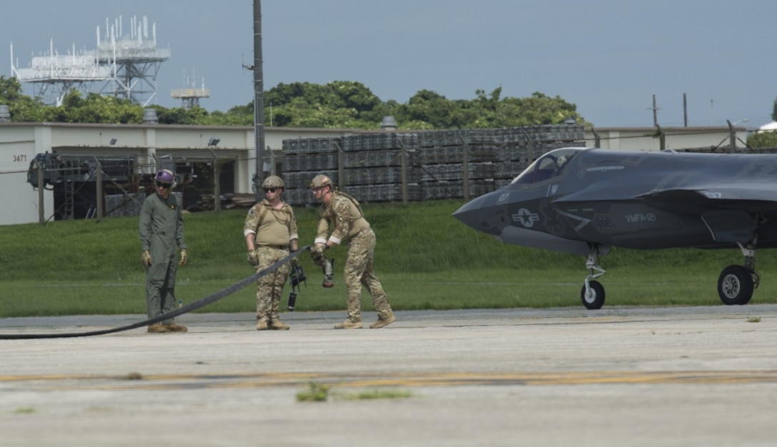 U.S. Marines and Airmen finish a hot pit refuel on the F-35B Lightning II aircraft at Kadena Air Force Base, Okinawa, Japan, June 27, 2017. The Marines are with Marine Fighter Attack Squadron 121, Marine Aircraft Group 12, 1st Marine Aircraft Wing, and the Airmen are with 353 Special Operations Group, 18th Wing. The two-day exercise enabled the U.S. Air Force and Marine Corps to improve interoperability and develop tactics, techniques and procedures involving the new aircraft for future joint FARP operations throughout the Indo-Asia Pacific Theater. (U.S. Marine Corps photo by Lance Cpl. Deseree Kamm) 