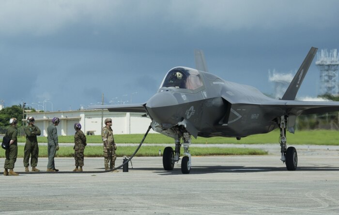 U.S. Marines and Airmen conduct a hot pit refuel on the F-35B Lightning II aircraft at Kadena Air Force Base, Okinawa, Japan, June 27, 2017. The Marines are with Marine Fighter Attack Squadron 121, Marine Aircraft Group 12, 1st Marine Aircraft Wing, and the Airmen are with 18th Logistics and Readiness Squadron, 353 Special Operations Group, 18th Wing. The two-day exercise enabled the U.S. Air Force and Marine Corps to improve interoperability and develop tactics, techniques and procedures involving the new aircraft for future joint FARP operations throughout the Indo-Asia Pacific Theater. (U.S. Marine Corps photo by Lance Cpl. Deseree Kamm) 