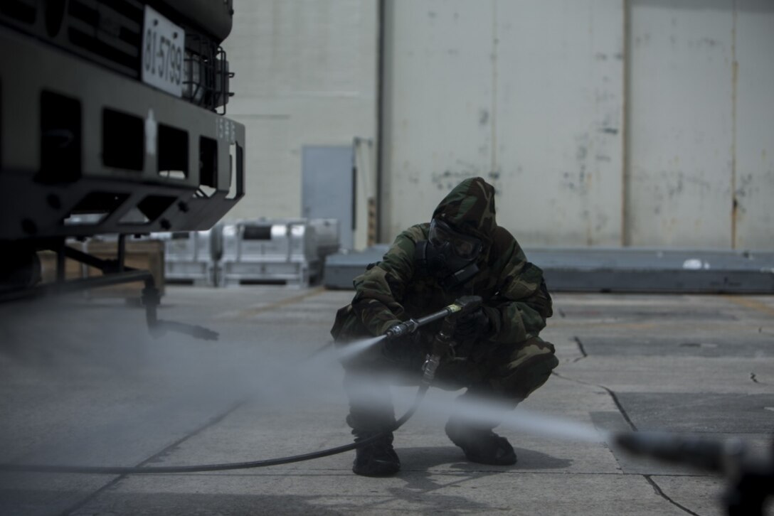 U.S. Marine Lance Cpl. Enrique Puentes Jr. decontaminates a Japanese Decontamination Truck during a simulated joint study with the Japanese Ground Self-Defense Force at Marine Corps Air Station Futenma, Okinawa, Japan, oJuly 13, 2017. Puentes, a native of Tampa, Florida, is a CBRN defense specialist with Marine Wing Headquarters Squadron 1. (U.S. Marine Corps photo by Cpl. Kelsey Dornfeld). 