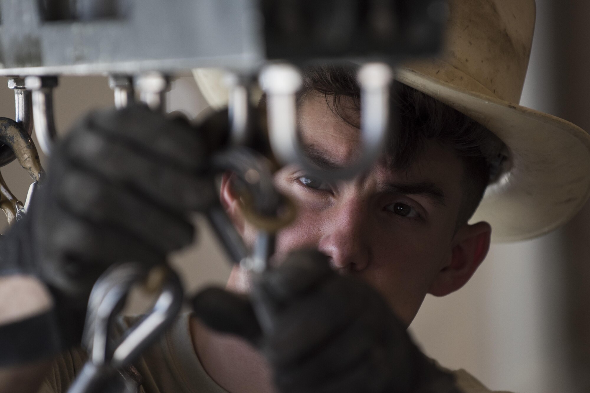 Staff Sgt. Noah Dankocsik, 332nd Expeditionary Maintenance Squadron maintenance crewmember, secures a GBU-12 laser-guided bomb before loading it on a pallet July 7, 2017, in Southwest Asia. The bombs will be mounted on an F-15E Strike Eagle in support of Operation Inherent Resolve. (U.S. Air Force photo/Senior Airman Damon Kasberg)