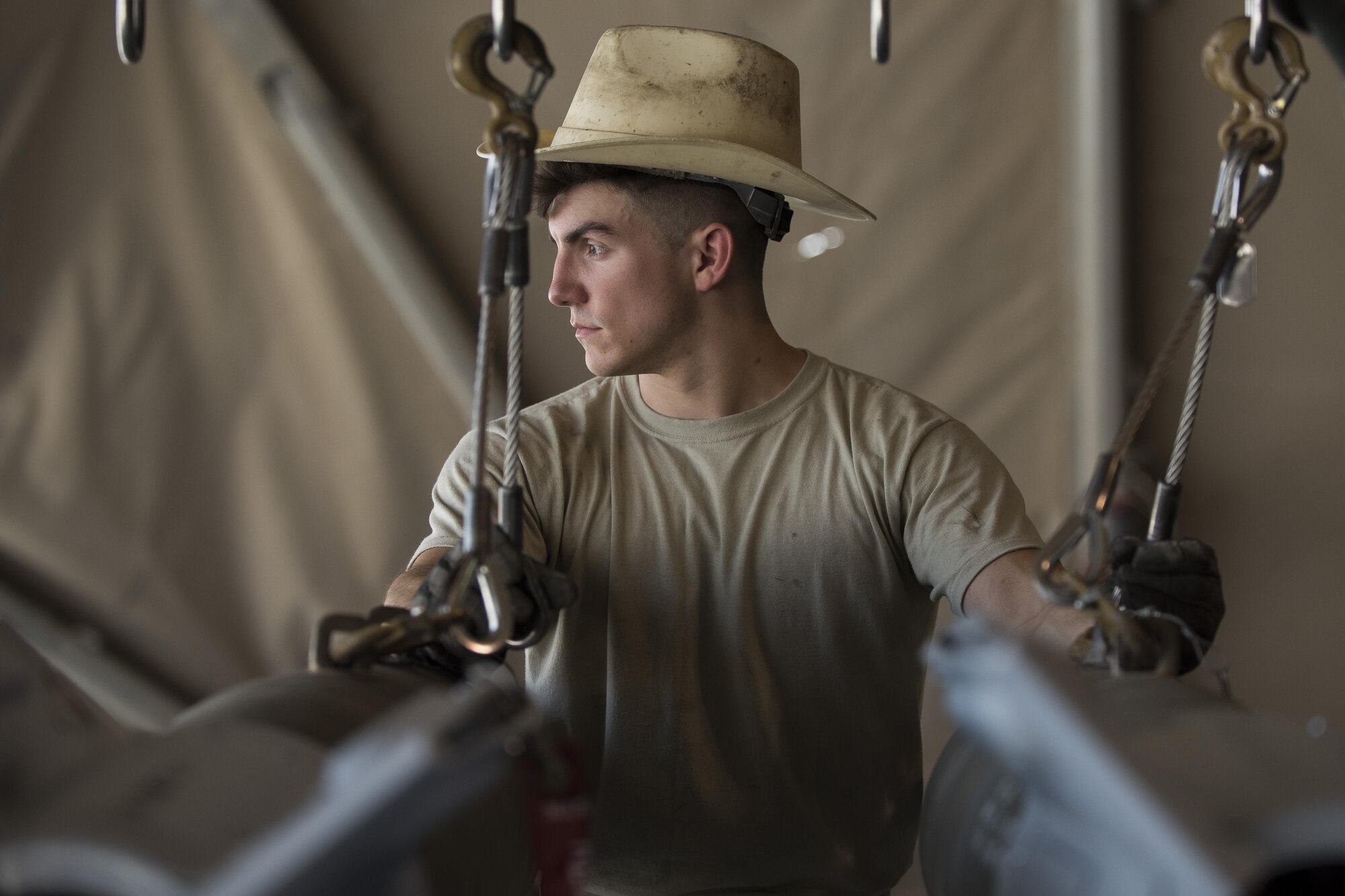 Staff Sgt. Noah Dankocsik, 332nd Expeditionary Maintenance Squadron maintenance crewmember, loads a GBU-12 laser-guided bomb on a pallet July 7, 2017, in Southwest Asia. The bombs will be mounted on an F-15E-Strike Eagle in support of Operation Inherent Resolve. (U.S. Air Force photo/Senior Airman Damon Kasberg)