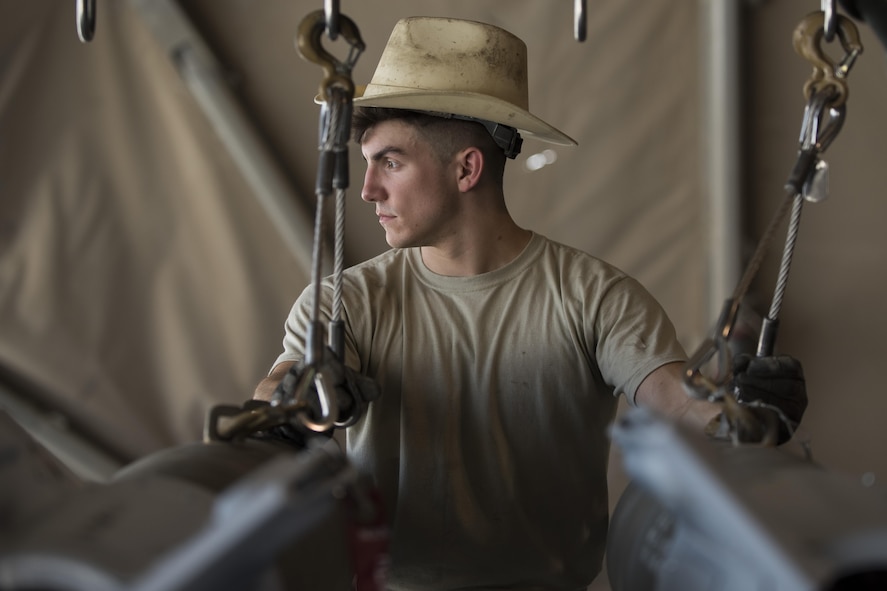 Staff Sgt. Noah Dankocsik, 332nd Expeditionary Maintenance Squadron maintenance crewmember, loads a GBU-12 laser-guided bomb on a pallet July 7, 2017, in Southwest Asia. The bombs will be mounted on an F-15E-Strike Eagle in support of Operation Inherent Resolve. (U.S. Air Force photo/Senior Airman Damon Kasberg)