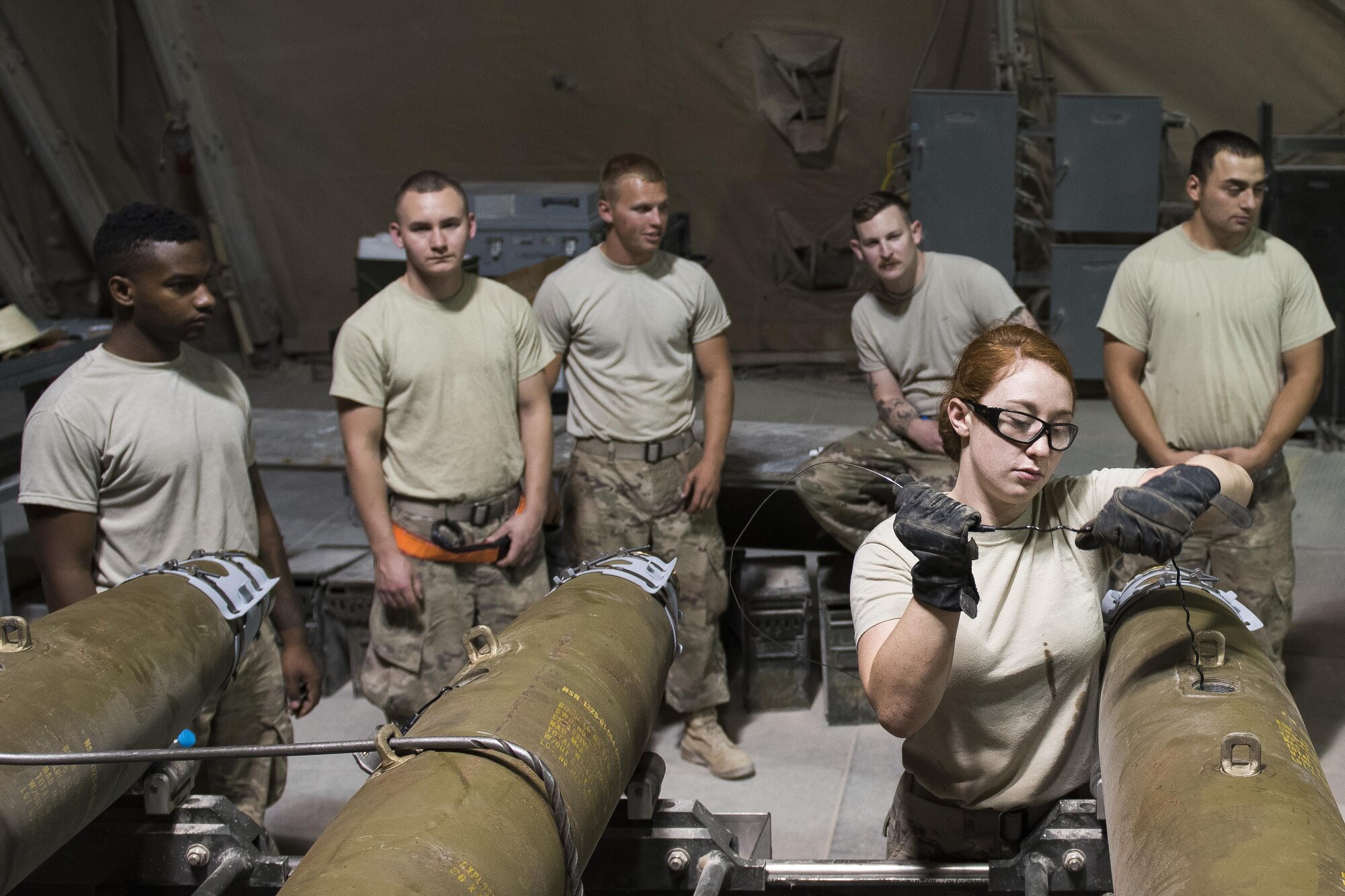Senior Airman Briana Cannon, 332nd Expeditionary Maintenance Squadron munitions stockpile management crewmember, prepares the fuse for a GBU-38, July 12, 2017, in Southwest Asia. The squadron builds and maintains a variety of munitions to arm F-15E Strike Eagles and MQ-9 Reapers in support of Operation Inherent Resolve. (U.S. Air Force photo/Senior Airman Damon Kasberg)