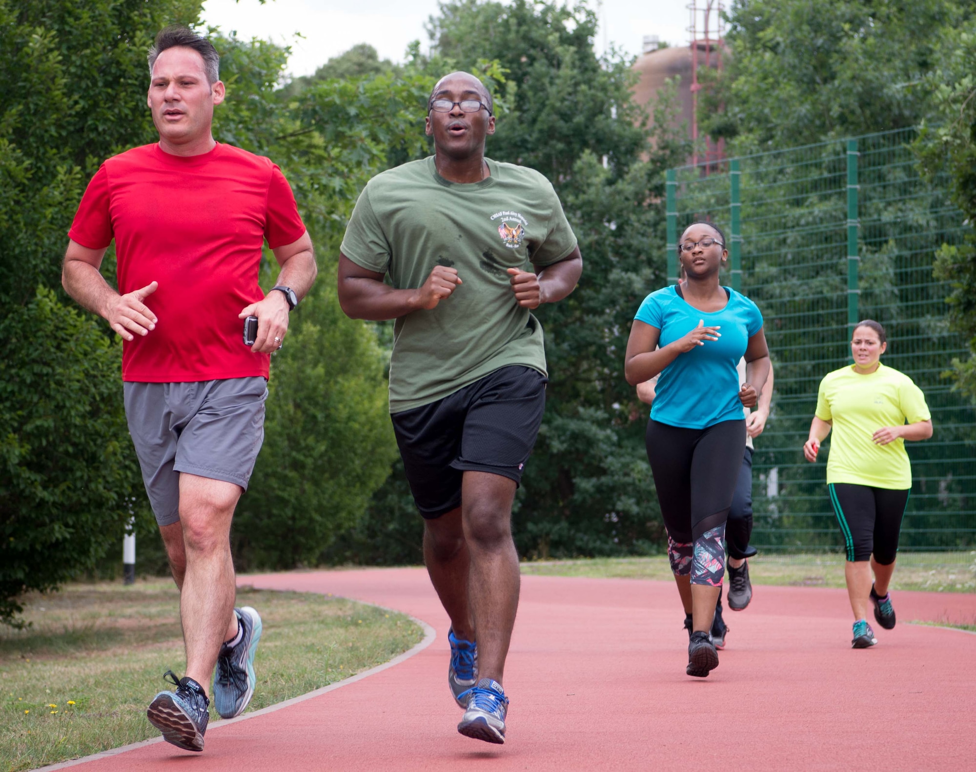 Participants in the 86th Medical Group physical therapy flight Pose Method run class jog as U.S. Air Force Tech. Sgt. Lizmarie Linares, right, 86th MDOS physical therapy flight chief, observes the mechanics of their stride on Ramstein Air Base, Germany, July 17, 2017. The Pose Method class is designed to help patients correct their stride, reduce or eliminate pain, and avoid future injury so that they can improve their scores on the cardiovascular component of the Air Force fitness tests. (U.S. Air Force photo by Senior Airman Elizabeth Baker)