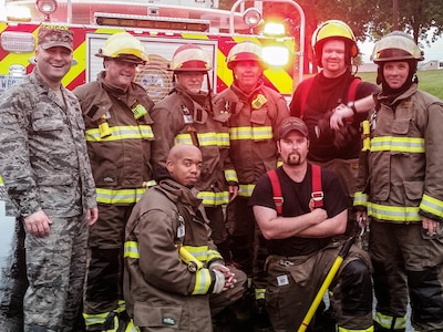 Maj. Ryan Walsh, District of Columbia National Guard’s Joint Force Headquarters – Air, Military Personnel Management Officer,  poses for a photo with members of the Camp J.T. Robinson Fire Department, Camp Robinson, Arkansas, April 26, 2017.