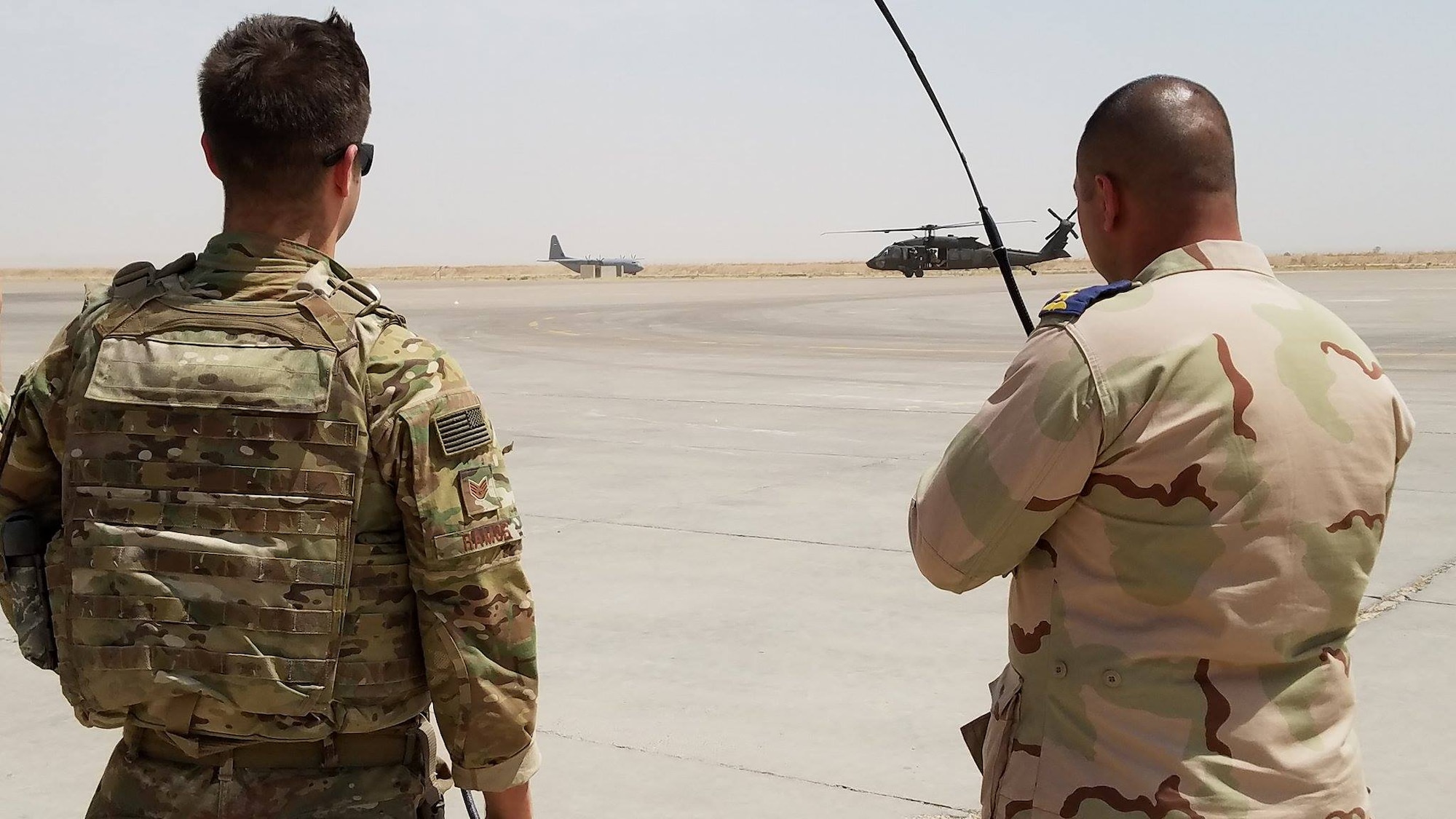 U.S. Air Force Staff Sgt. Matthew Ramos, an air traffic controller deployed in support of Combined Joint Task Force – Operation Inherent Resolve and assigned to  the 370th Air Expeditionary Advisory Group, Detachment 1, works with an Iraqi air force air traffic controller to coordinate the arrival of incoming aircraft at Qayyarah West Airfield, Iraq, July 1, 2017. To ensure seamless control of both Iraqi and Coalition air traffic, the U.S. Air Force’s 370th supports the CJTF-OIR advise and assist mission by having a small team of air advisors at Qayyarah West airfield working alongside the Iraqis advising and assisting in day-to-day airfield operations. CJTF-OIR is the global Coalition to defeat ISIS in Iraq and Syria.  (U.S. Air Force photo by Tech. Sgt. Jonathan Hehnly)