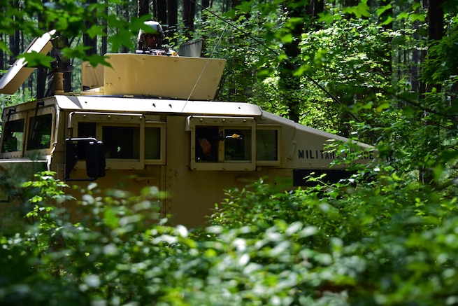 Members of the 166th Civil Engineer Squadron, Delaware Air National Guard, scan for aggressors during convoy operations training at Redden State Forest, Georgetown, De., 15 July 2017. (U.S. Air National Guard photo by SSgt. Andrew Horgan/released)