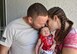 Staff Sgt. Jeff A. Parrish Jr., left, 920th Aircraft Maintenance Squadron aircraft armament systems technician, and his wife, Jacquelyne Parrish, kiss their daughter Raelynn Noelle Parrish, July 4, 2017, outside of their home in Ocoee, Florida. Jeff returned home shortly before the early birth of their first child after a four-month deployment to Afghanistan. (Courtesy photo) 