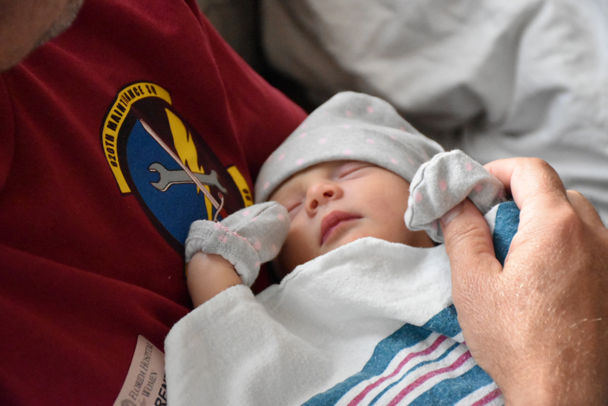 Tech. Sgt. Jeff A. Parrish, 920th Maintenance Squadron munitions assistant flight chief, holds his first grandchild, Raelynn Noelle Parrish, June 16, 2017 the day after her birth in a hospital in Orlando, Florida. Parrish and his son, Staff Sgt. Jeff A. Parrish Jr., Raelynn's father, were both deployed for the four months leading up to the baby's birth. Jeff Jr. is an aircraft armament systems technician with the 920th Aircraft Maintenance Squadron. (Courtesy photo)