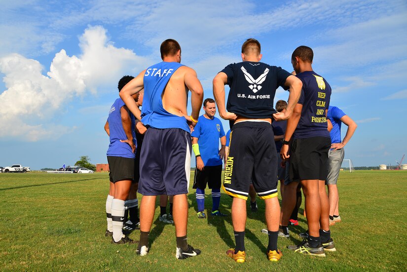 The 497th Operations Support Squadron soccer team discuss their game plan before the start of the Intramural Soccer Championship at Joint Base Langley-Eustis, Va., July 12, 2017. The 497th OSS competed against the 1st Operations Support Squadron and came out on top with a final score of 2-1. (U.S. Air Force photo/ Airman Alexandra Naranjo)