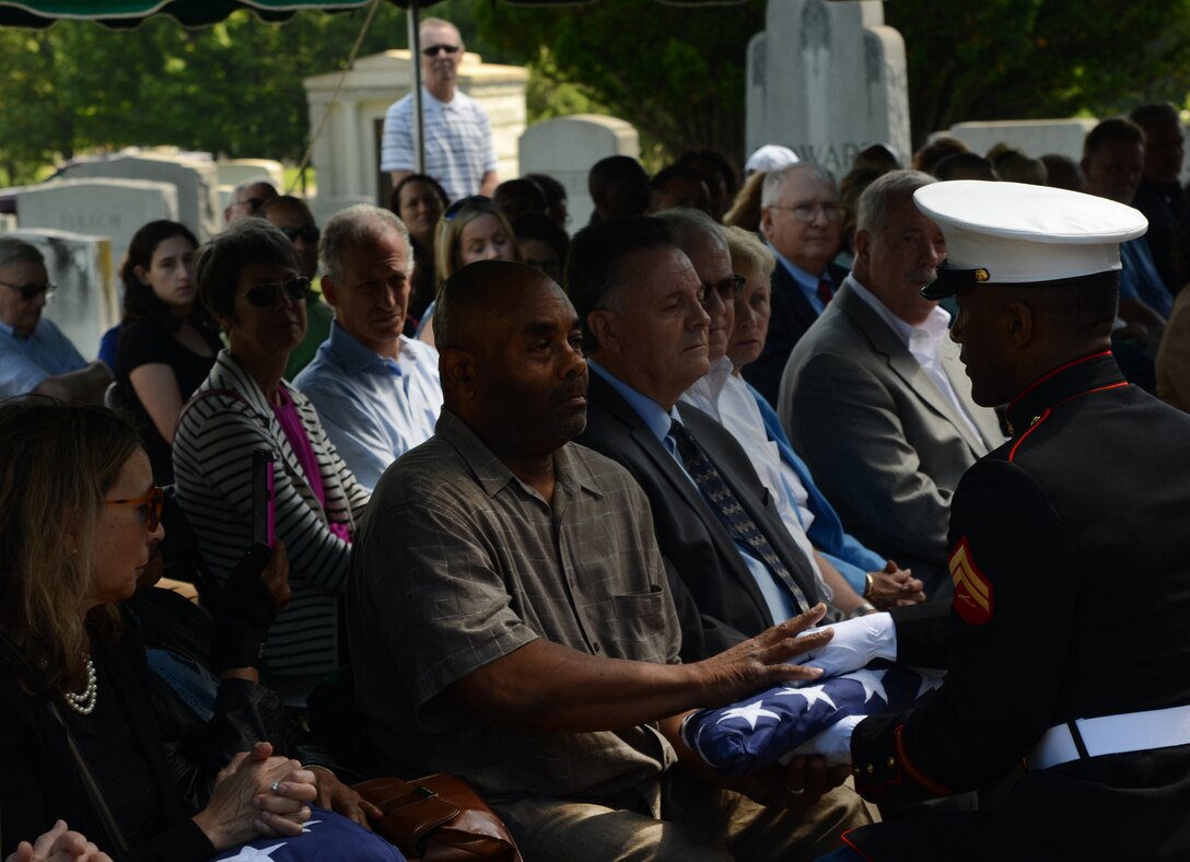 Leroy Drummond, receives his uncle's flag from a member of the honor guard, Baltimore, Md., June 6, 2017. Drummond's uncle, Cornelius Booker, a veteran of the 82nd Airborne Division, was laid to rest in the Druid Ridge Cemetery. Photo cropped and dodged for enhancement purposes. (U.S. Army National Guard photo by Spc. Michael Tanner)