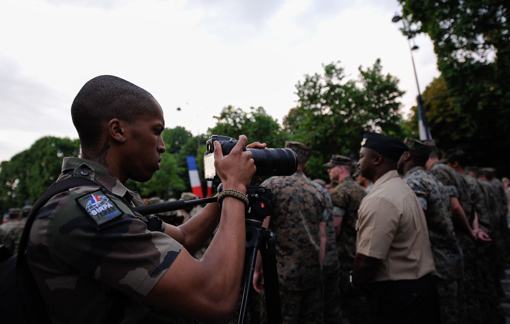 An Armée de Terre photographer takes photos of U.S. military members during a Bastille Day military parade rehearsal at the Avenue des Champs-Élysées, France, July 10, 2017. More than 200 U.S. service members led the Bastille Day military parade on July 14, 2017, to commemorate the 100 year anniversary of the U.S. entering World War I and joining the allied forces. (U.S. Air Force photo by Airman 1st Class Savannah L. Waters)