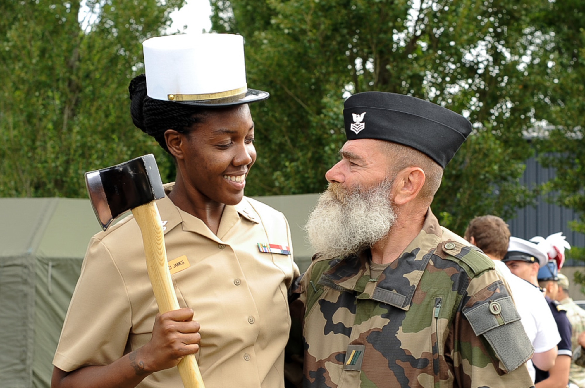A U.S. Navy Seaman and a member of the Armée de Terre switch hats for a photo at Camp de Satory, France, July 12, 2017. During rehearsals, military members from countries had the opportunity to interact and learn from the other’s military traditions and culture, further strengthening the bond between old allies. (U.S. Air Force photo by Airman 1st Class Savannah L. Waters)