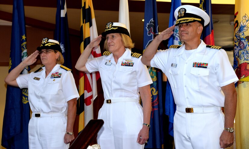 U.S. Navy Capt. Dale Barrette, right, assumes command of Naval Health Clinic Charleston from Capt. Elizabeth Maley, center, during a change of command ceremony July 7, 2017 at NHCC on Joint Base Charleston – Weapons Station. Rear Adm. Anne Swap, left, Navy Medicine East commander and Navy Medical Service Corps director, presided over the ceremony. Barrette joins NHCC from Naval Hospital Sigonella, Italy, where he served as the command’s executive officer since July 2015.