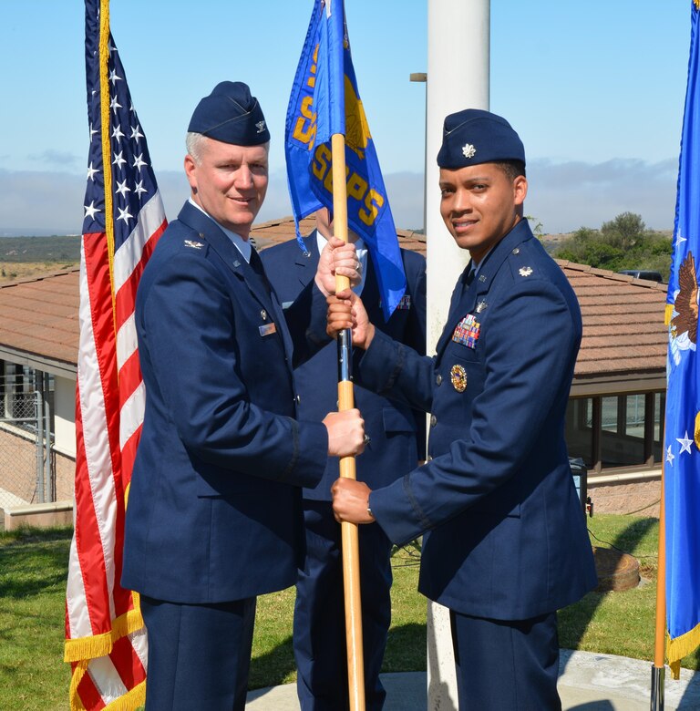 Col. William Angerman, 50th Network Operations Group commander, hands the 21st Space Operations Squadron guidon to the squadron’s new commander, Lt. Col. Wade McGrew, during the unit’s change of command ceremony at Vandenberg Air Force Base, California, July 13, 2017. McGrew was preceded by Lt. Col. Philip Verroco. (U.S. Air Force photo/Maj. Jason Brown)