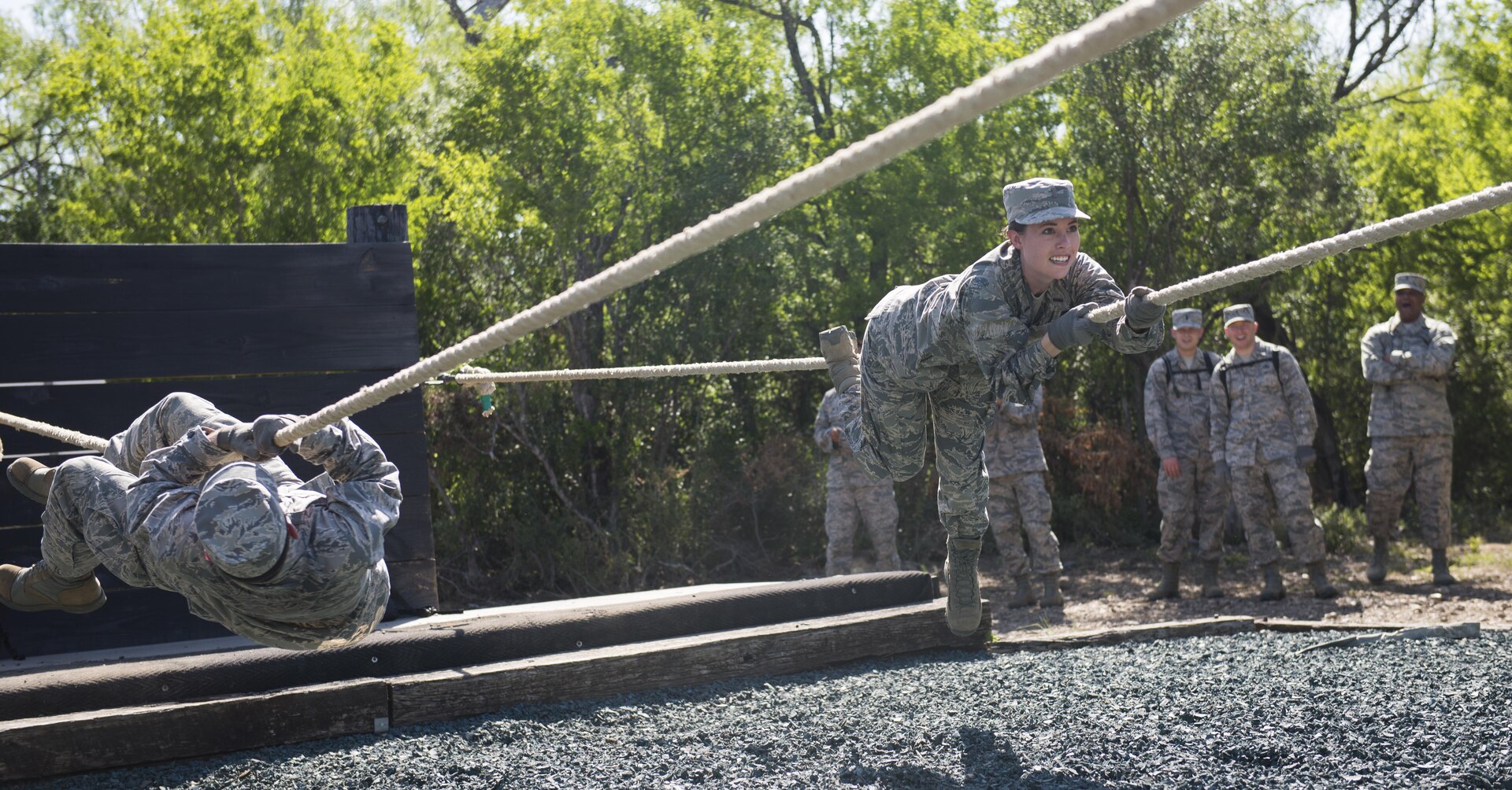 Chaplain candidates attempt to complete one of the Creating Leader Airmen Warriors, or CLAW, course's obstacles during a tour of the Basic Expeditionary Airmen Skills Training at Joint Base San Antonio-Lackland, Texas, July 5, 2017. The tour was part of the Chaplain Candidate Intensive Internship. (U.S. Air Force photo by Senior Airman Krystal Wright)