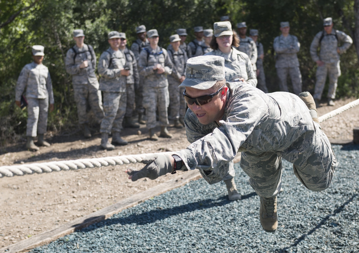 A chaplain candidate attempts to complete one of the  Creating Leader Airmen Warriors, or CLAW, course's obstacles during a tour of the Basic Expeditionary Airmen Skills Training at Joint Base San Antonio-Lackland, Texas, July 5, 2017. The tour was part of the Chaplain Candidate Intensive Internship. (U.S. Air Force photo by Senior Airman Krystal Wright)