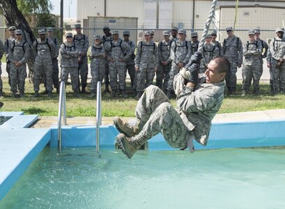Chaplain candidates watch basic military trainees attempt to complete one of the Creating Leader Airmen Warriors, or CLAW, course's obstacles during a tour of the Basic Expeditionary Airmen Skills Training at Joint Base San Antonio-Lackland, Texas, July 5, 2017. The tour was part of the Chaplain Candidate Intensive Internship. (U.S. Air Force photo by Senior Airman Krystal Wright)