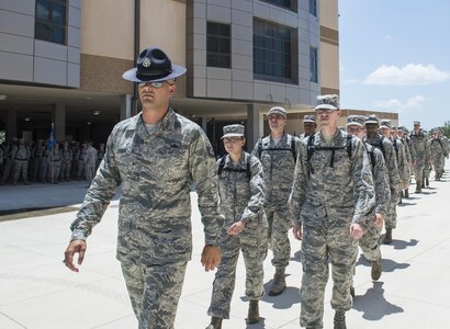 Tech. Sgt. Paul Couch, 323rd Training Squadron military training instructor, provides a tour to chaplain candidates of an Airman Training Complex at Joint Base San Antonio-Lackland, Texas, July 5, 2017. The tour was part of the Chaplain Candidate Intensive Internship. (U.S. Air Force photo by Senior Airman Krystal Wright)