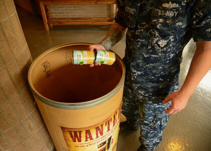 Charleston, S.C. (Jul 17, 2017) Petty Officer 2nd Class Christopher Bradford, Naval Support Activity administrative assistant, donates canned food in support of Feds Feed Families at the All Saints Chapel on Joint Base Charleston - Weapons Station. Feds Feed Families was created to help food banks and pantries stay stocked during summer months when they traditionally see a decrease in donations and an increase in need.