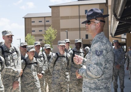 Tech. Sgt. Paul Couch, 323rd Training Squadron military training instructor, provides a tour to chaplain candidates of an Airman Training Complex at Joint Base San Antonio-Lackland, Texas, July 5, 2017. The tour was part of the Chaplain Candidate Intensive Internship. (U.S. Air Force photo by Senior Airman Krystal Wright)