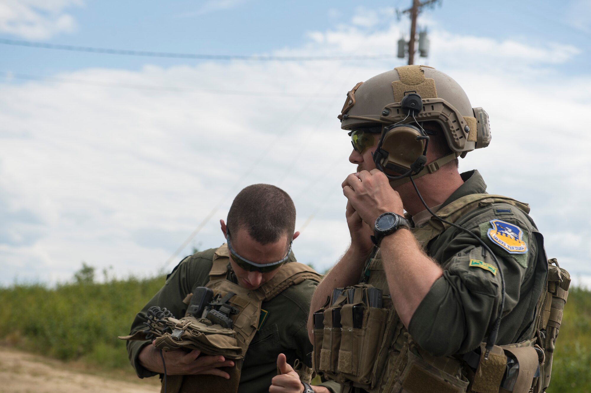 U.S. Air Force 1st Lt.’s Julian Rooks and Kevin Long, both A-10 Thunderbolt II pilots assigned to the 25th Fighter Squadron out of Osan Air Base, South Korea, put on protective equipment June 29, 2017, on the Joint Pacific Alaska Range Complex, Delta Junction, Alaska. Both Rooks and Long were afforded the chance to see their mission happen from the perspective of a Tactical Air Control Party Airman. (U.S. Air Force photo by Airman 1st Class Isaac Johnson)
