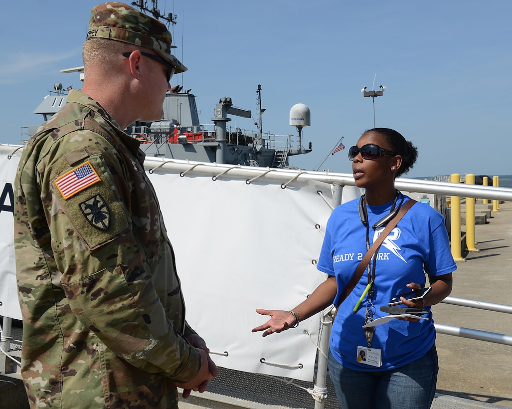 (From right) Kendra Wormley, Versability Resources senior operations manager, briefly explains the need for sign language interpreters to U.S. Army Chief Warrant Officer 2 Kevin Toomey, 7th Transportation Brigade (Expeditionary) U.S. Army Vessel Brandy Station vessel master, during a Ready 2 Work program visit to Joint Base Langley-Eustis, Va., July 14, 2017. Students in the program range from 15 to 21 years old and either face intellectual developmental disabilities, or are considered “at risk” by the Newport News school system. (U.S. Air Force photo/Staff Sgt. Teresa J. Cleveland)