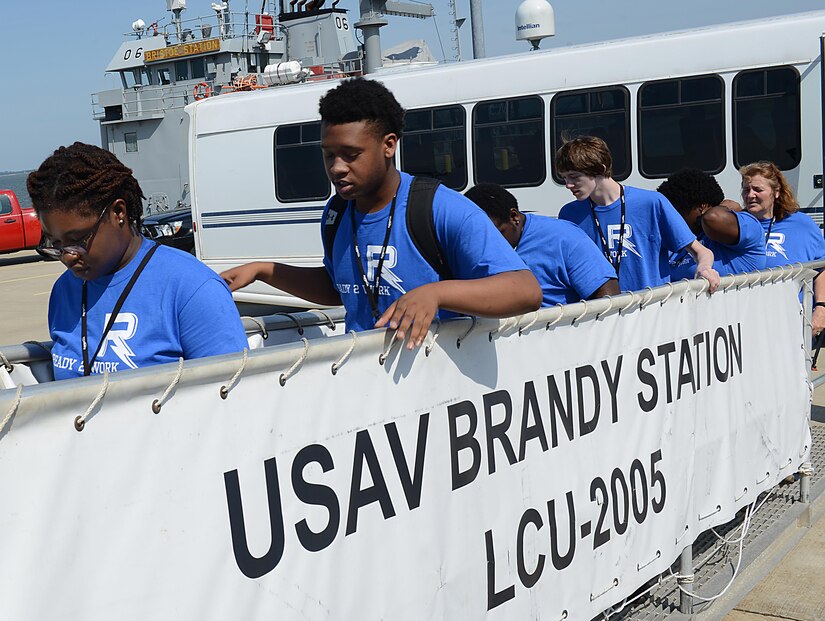 Students from the Ready 2 Work program climb aboard the U.S. Army Vessel Brandy Station, during a visit to Joint Base Langley-Eustis, Va., July 14, 2017. During their visit, program participants learned how Third Port supports the local community. (U.S. Air Force photo/Staff Sgt. Teresa J. Cleveland)