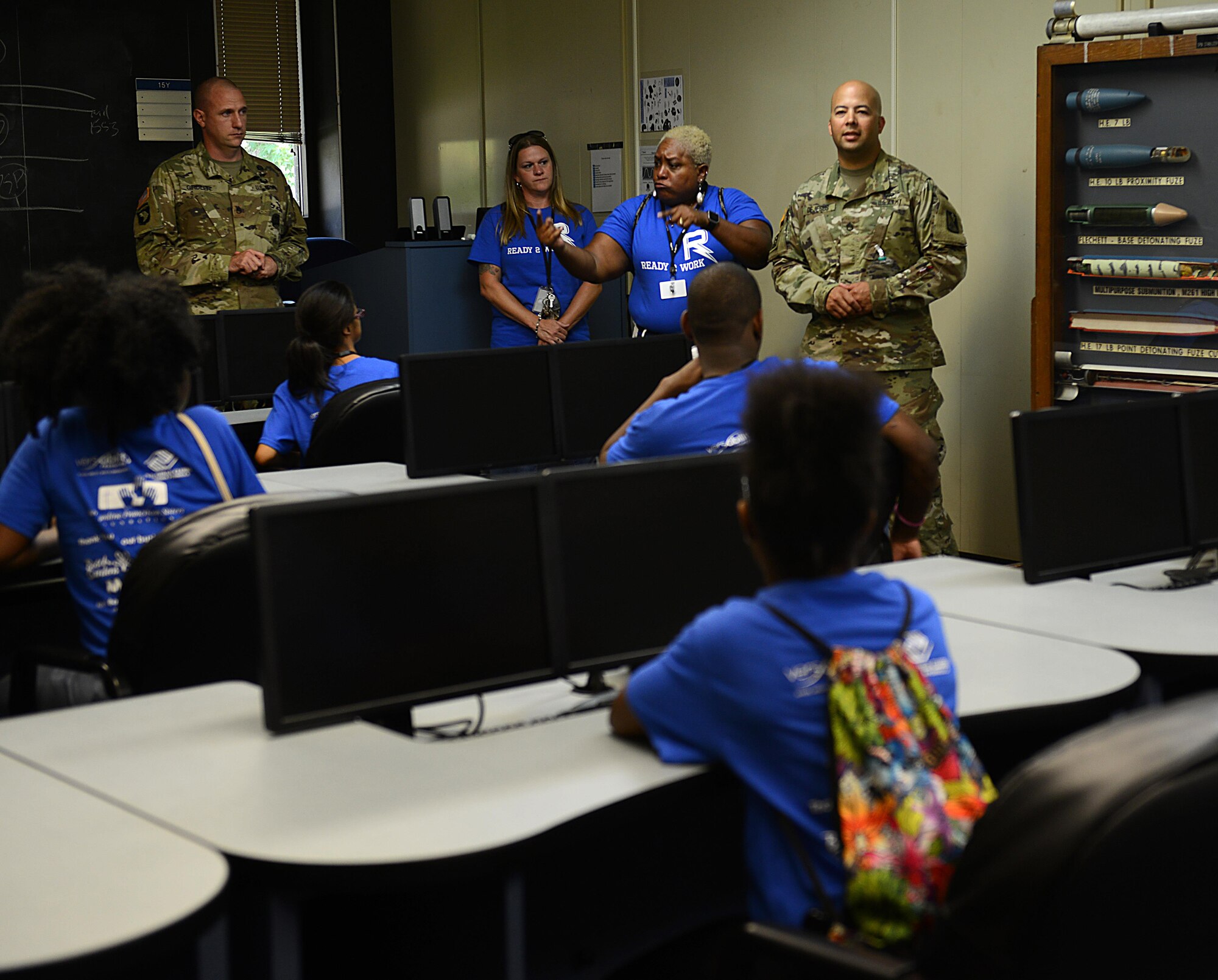 Karen King, Newport News Public Schools sign language interpreter, uses sign language as U.S. Army Staff Sgt. Edmar DeJesus, 1st Battalion, 210th Aviation Regiment, 128th Aviation Brigade AH-64D Apache helicopter instructor, provides information on weapon systems used on the aircraft at Joint Base Langley-Eustis, Va., July 14, 2017. During the visit, sign language interpreters were used to aid deaf or hard of hearing students in the Ready 2 Work program. (U.S. Air Force photo/Staff Sgt. Teresa J. Cleveland)
