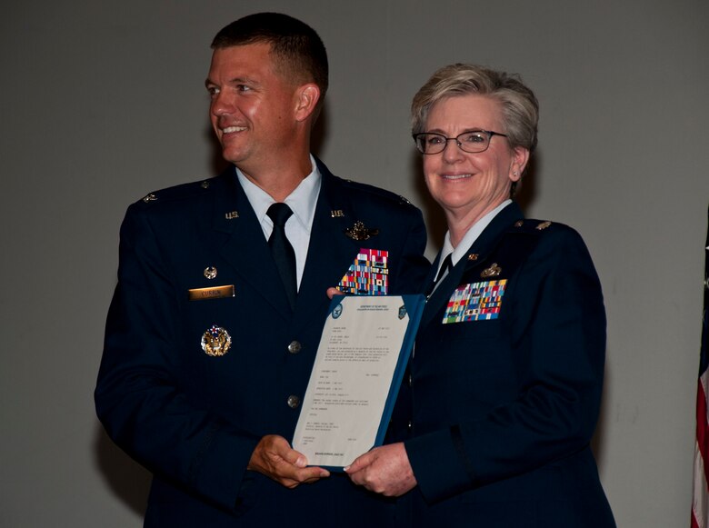 U.S. Air Force Col. Scovill W. Currin, Commander of the 916th Air Refueling Wing, poses with newly promoted Col. Kelly E. Hosey, Commander of the 916th Mission Support Group, at Seymour Johnson Air Force Base, N.C., July 16, 2017. Hosey, began her Air Force career in 1980, when she enlisted onto active duty out of Chicopee, Ma. (U.S. Air Force photo by Senior Airman Kayla Newman)