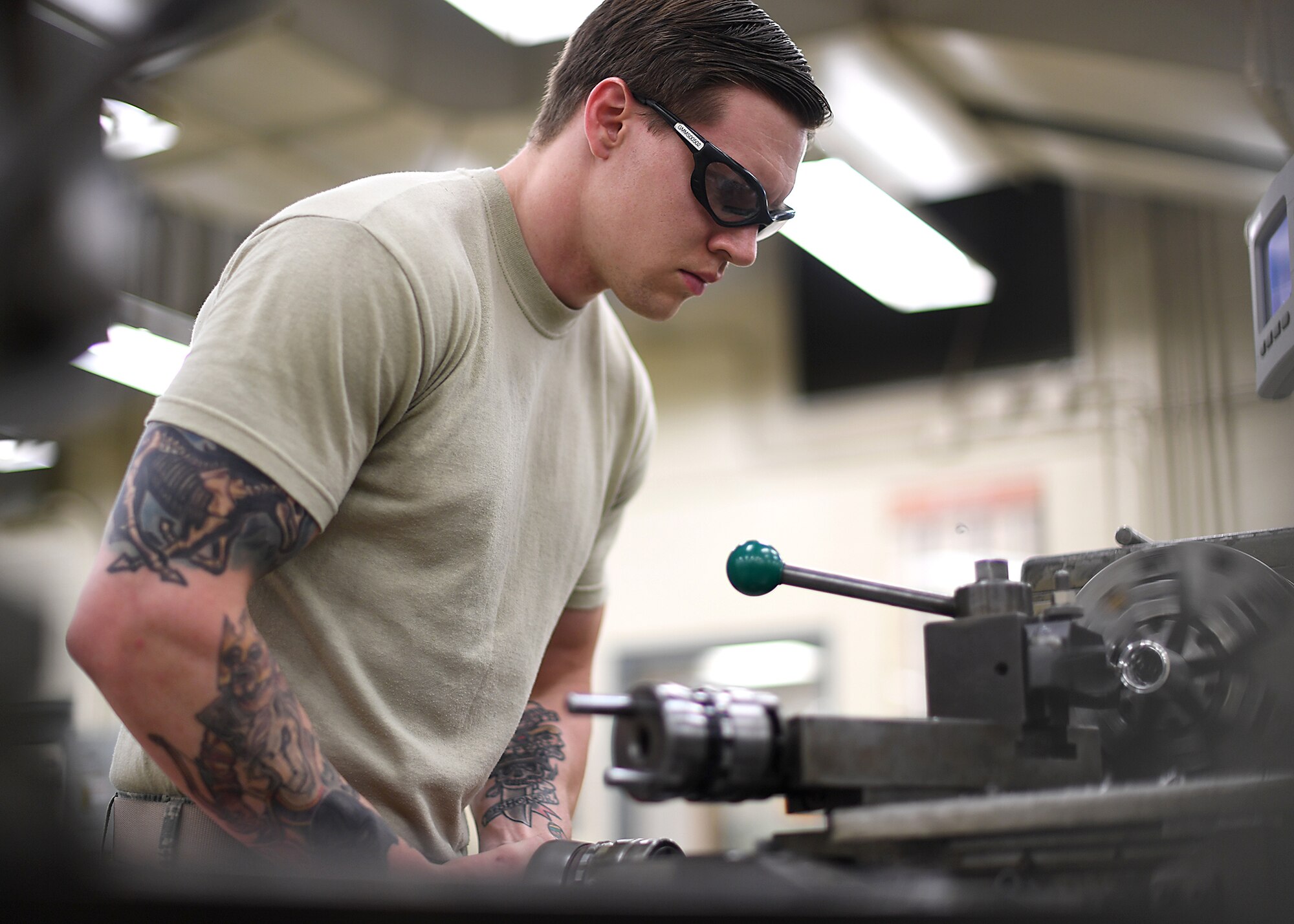 Airman 1st Class Charles Buchanan, 69th Maintenance Squadron aircraft metals technology journeyman, uses a lathe to build a new part July 13, 2017, on Grand Forks Air Force Base, N.D. Buchanan and other Airmen with the 69 MXS fabricated a new part for an RQ-4 Global Hawk, which allowed the Air Force to save money and the mission to continue. (U.S. Air Force photo by Senior Airman Ryan Sparks)