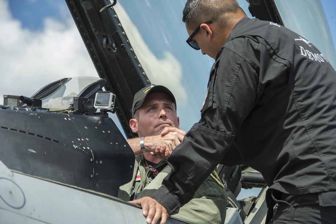 U.S. Air Force Maj. John “Rain” Waters, Air Combat Command F-16 Viper Demonstration Team commander and pilot, shakes hands with Tech. Sgt. Stephen Mullins, ACC F-16 Viper Demonstration Team avionics specialist, before takeoff at the F-AIR COLOMBIA 2017 air show in Rionegro, Colombia, July 15, 2017. Waters and his teammates gave the Colombian people a better understanding of the U.S. Air Force’s capabilities by performing four aerial demonstrations in support of the bi-annual air show. (U.S. Air Force photo by Staff Sgt. Zade Vadnais)