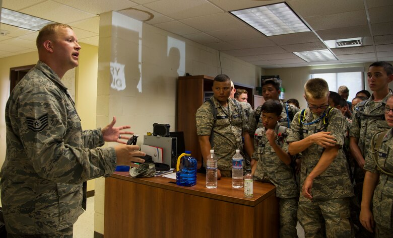 Tech. Sgt. David Yaroncyk, Joint Base Security military working dog kennel master, briefs cadets from the Civil Air Patrol during their visit to the 15th Wing as part of their encampment, Joint Base Pearl Harbor-Hickam, Hawaii, July 14, 2017. Encampment is a week-long program, during which cadets are immersed into a modified Air Force basic training environment. Cadets learned the basics of military life with physically and mentally challenging activities. (U.S. Air Force photo by Tech. Sgt. Heather Redman)