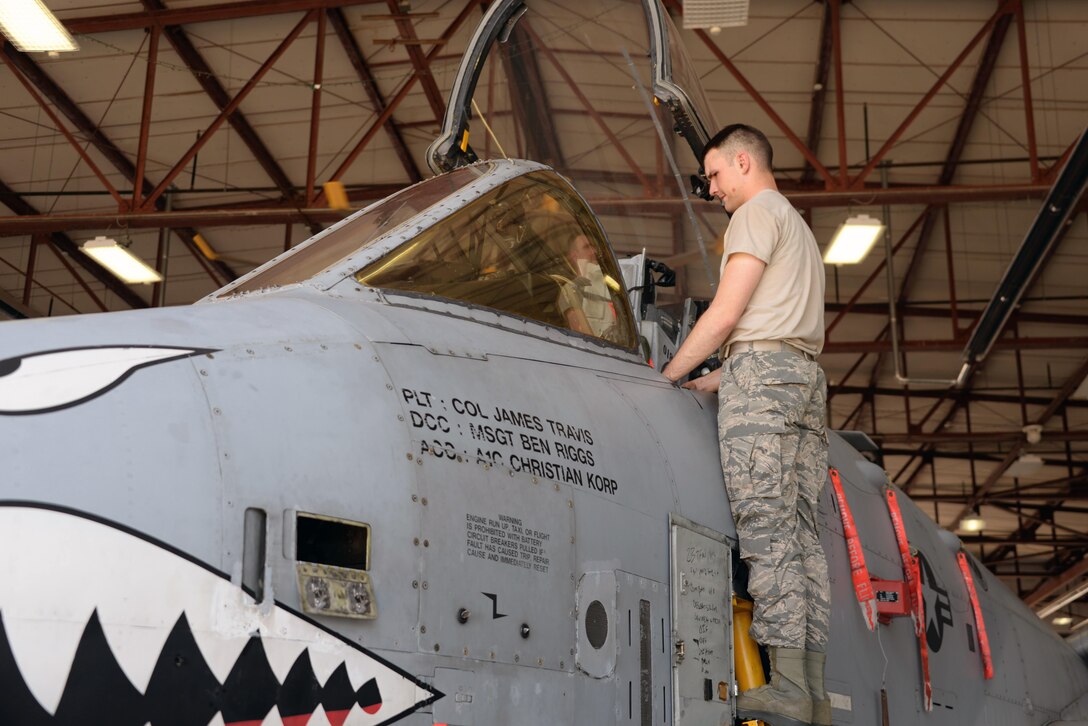 Airman Tryston Stanfield, 362nd Training Squadron A-10 crew chief apprentice course student, aides his classmate in raising the windshield to gain access to the avionics boxes. Avionics boxes need to be accessible in case of electronics malfunctions. (U.S. Air Force Photo by Senior Airman Robert L. McIlrath)
