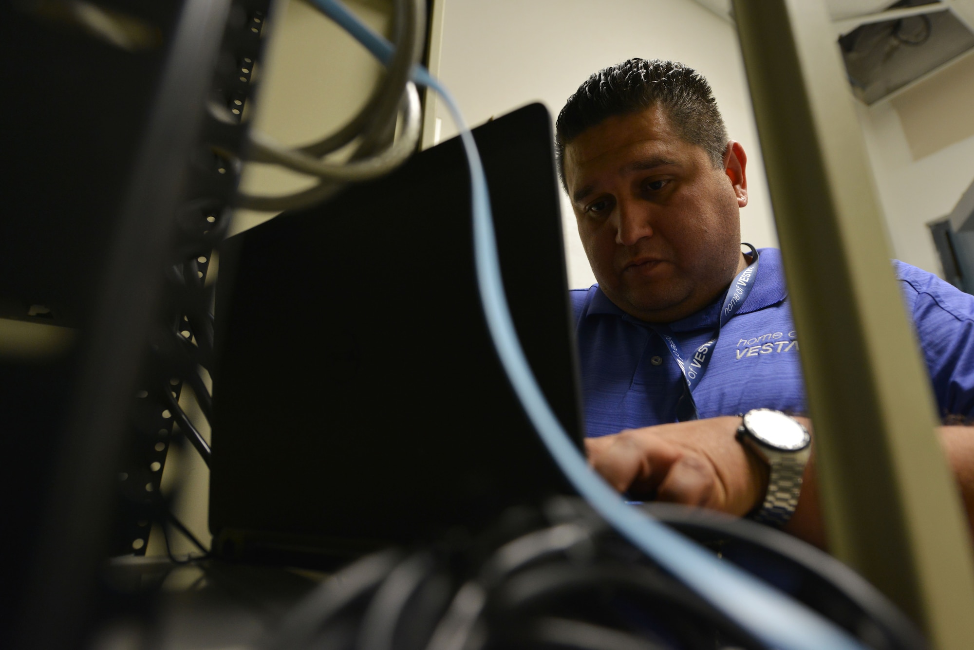 Jimmie De Armes, field engineer, configures a route from the emergency consoles to the communications server to allow the two systems to communicate at Shaw Air Force Base, S.C., July 12, 2017. De Armes configured the route for the Enhanced 911 system which received software and hardware updates, increasing speed and security. (U.S. Air Force photo by Airman 1st Class Destinee Sweeney)