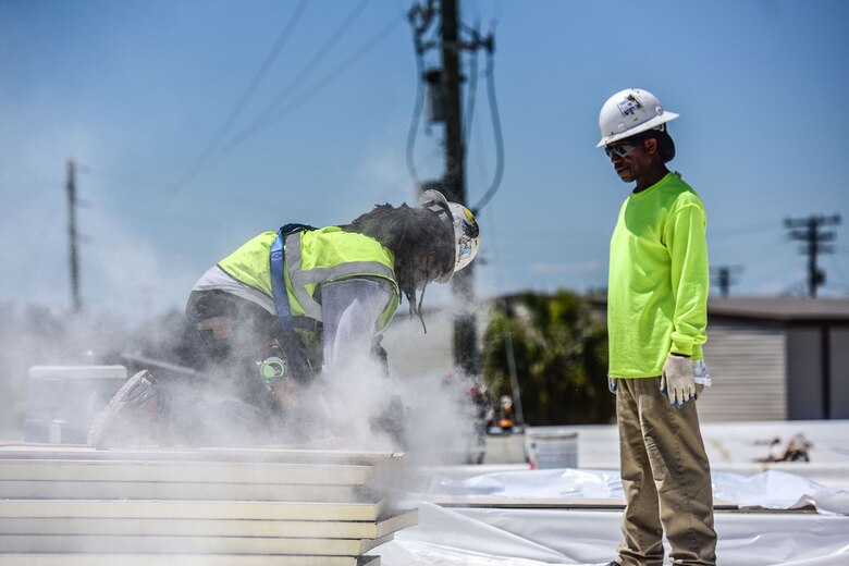Jamel Moody, a civilian contractor, cuts sheet rock on the roof of the Base Operations building during a renovation project at McEntire Joint National Guard Base, S.C., June 8, 2017. Select buildings and runway sections are undergoing renovations designed and contracted by the 169th Civil Engineer Squadron which will aid training missions of Swamp Fox Airmen. (U.S. Air National Guard photo by Senior Airman Megan Floyd)