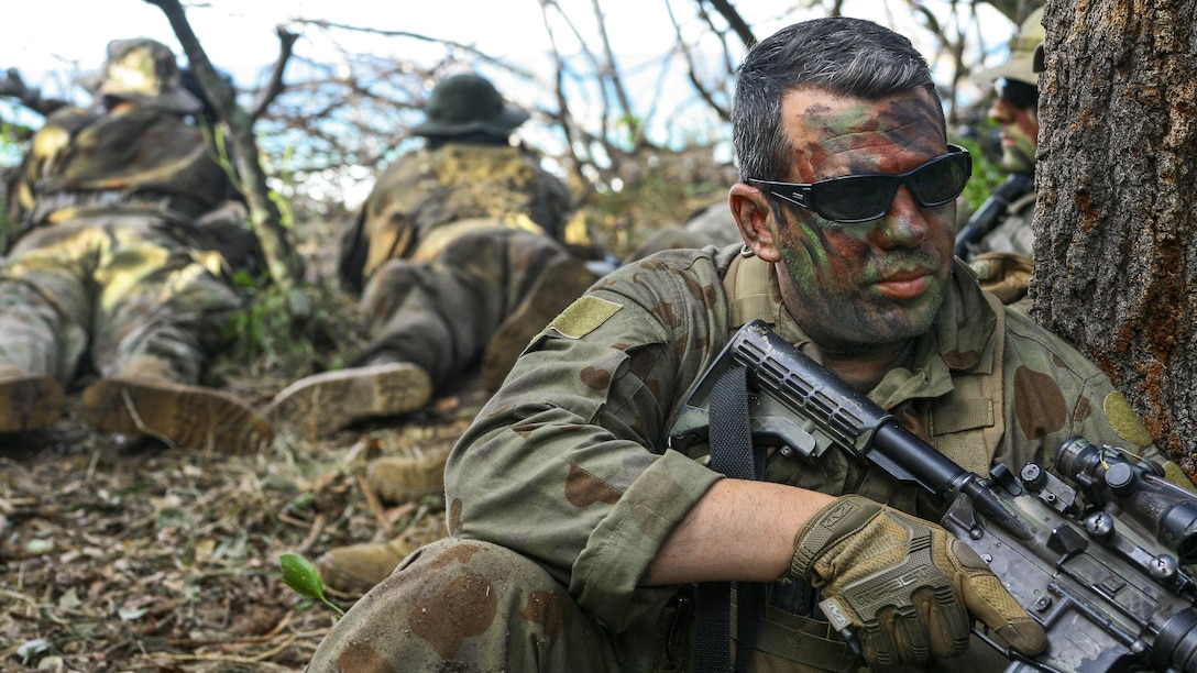 Army Sgt. Anthony Coppola guards an observation post at Shoalwater Bay, Queensland, Australia, July 14, 2017, during exercise Talisman Saber with Australian and New Zealand forces. Coppola is an assistant team leader assigned to the New York Army National Guard's 2nd Squadron, 101st Cavalry Regiment. He wore a mix of Australian and American uniform items because of the unit's role as an opposing force. Army National Guard photo by Sgt. Alexander Rector