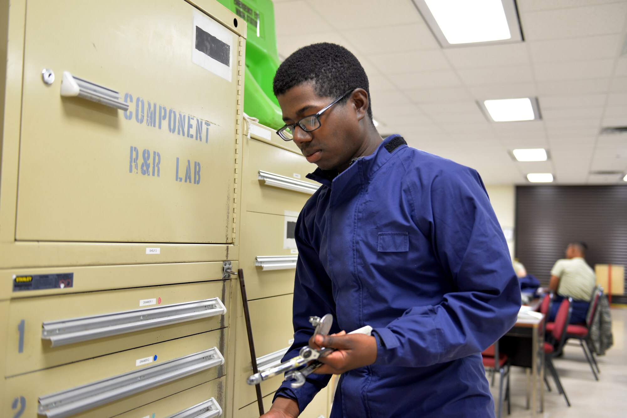 Airman Malik Jackson, 361st Training Squadron aircraft fuel systems apprentice course student learns to diagnose and repair fuel system malfunctions at Sheppard Air Force Base, Texas, July 11, 2017. He serves as the runner, or the person in charge of gathering tools for removing and replacing the No. 2 dump pump in a C-130 wing. (U.S. Air Force photo/Liz H. Colunga)