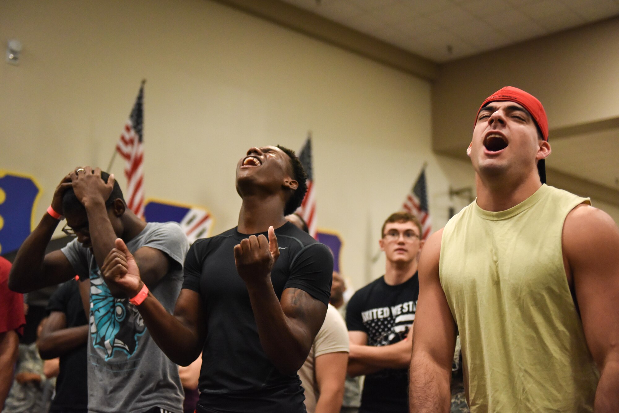 Members of Team Barksdale react to one of their fellow wingmen as they attempt the Alpha Warrior course at Barksdale Air Force Base, La., July 11, 2017. The Alpha Warrior flagship location in San Antonio, TX holds the largest pure obstacle installment available to civilians and military members for competition. (U.S. Air Force photo/Airman 1st Class Stuart Bright)