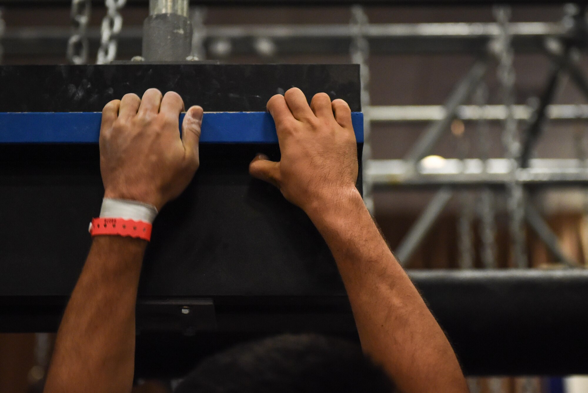 A member of Team Barksdale grips tightly to one of the Alpha Warrior obstacles at Barksdale Air Force Base, La., July 11, 2017. Alpha Warrior left behind one of their obstacle courses for Airmen to use, which is located in the SrA Bell Fitness Center. (U.S. Air Force photo/Airman 1st Class Stuart Bright)