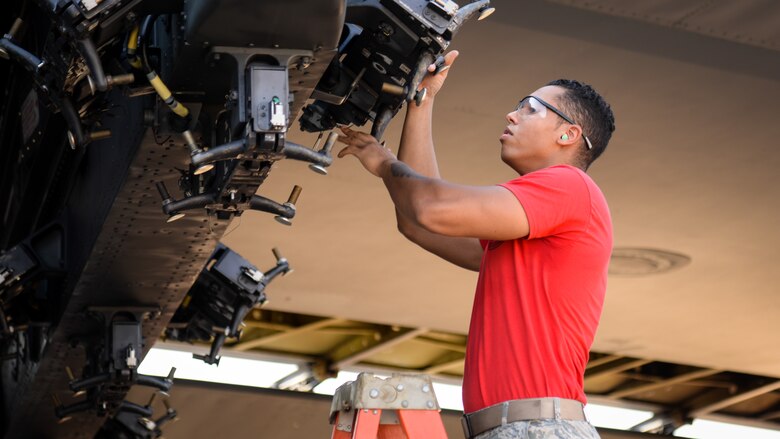 Airman 1st Class Jovany Rodriguez, 96th Aircraft Maintenance Unit weapons load crew member, inspects a MAU-12 for serviceability during a weapons load competition at Barksdale Air Force Base, La., July 7, 2017. The 96th AMU won the competition against the 20th with an upload time of 23 minutes, 30 seconds. (U.S Air Force photo/Staff Sgt. Benjamin Raughton)
