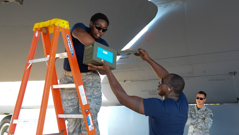 Senior Airman Ja’Mouri Moye, 20th Aircraft Maintenance Unit weapons load crew member, right, assists his teammate, Senior Airman Sheena Gabel, 20th AMU weapons load crew member, during a competition at Barksdale Air Force Base, La,. July 7, 2017. Moye said his first step in a competition is to consider anything he can do to minimize time to achieve victory against the 96th.
 (U.S Air Force photo/Staff Sgt. Benjamin Raughton)
