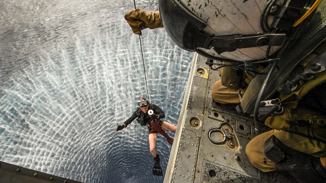 Navy Petty Officer 3rd Class Robert Marsh hoists Petty Officer 2nd Class Ruslan Garver into an MH-60S Seahawk helicopter during search-and-rescue drills with the USS Bataan in the U.S. 5th Fleet area of operations, July 14, 2017. The ship is supporting maritime security operations to reassure allies and partners, and preserve the freedom of navigation and flow of commerce in the region. Navy photo by Petty Officer 3rd Class Evan Thompson