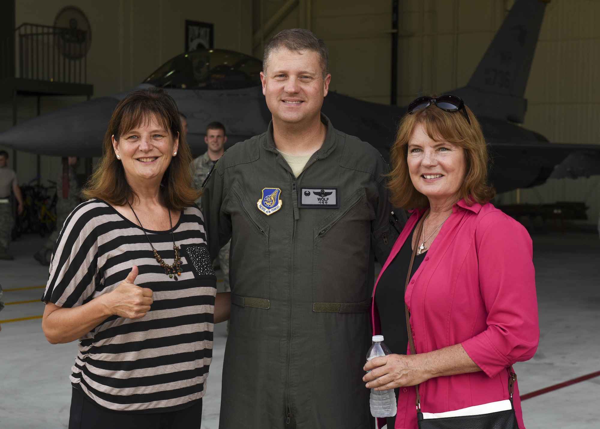 Christina Olds, daughter of Brig. Gen. Robin Olds, and Catherine Cook stand with Col. David Shoemaker, 8th Fighter Wing commander, before a weapons load competition at Kunsan Air Base, Republic of Korea, July 14, 2017. The visit commemorated what would have been Robin Olds 95th birthday. (U.S. Air Force photo by Senior Airman Michael Hunsaker/Released)