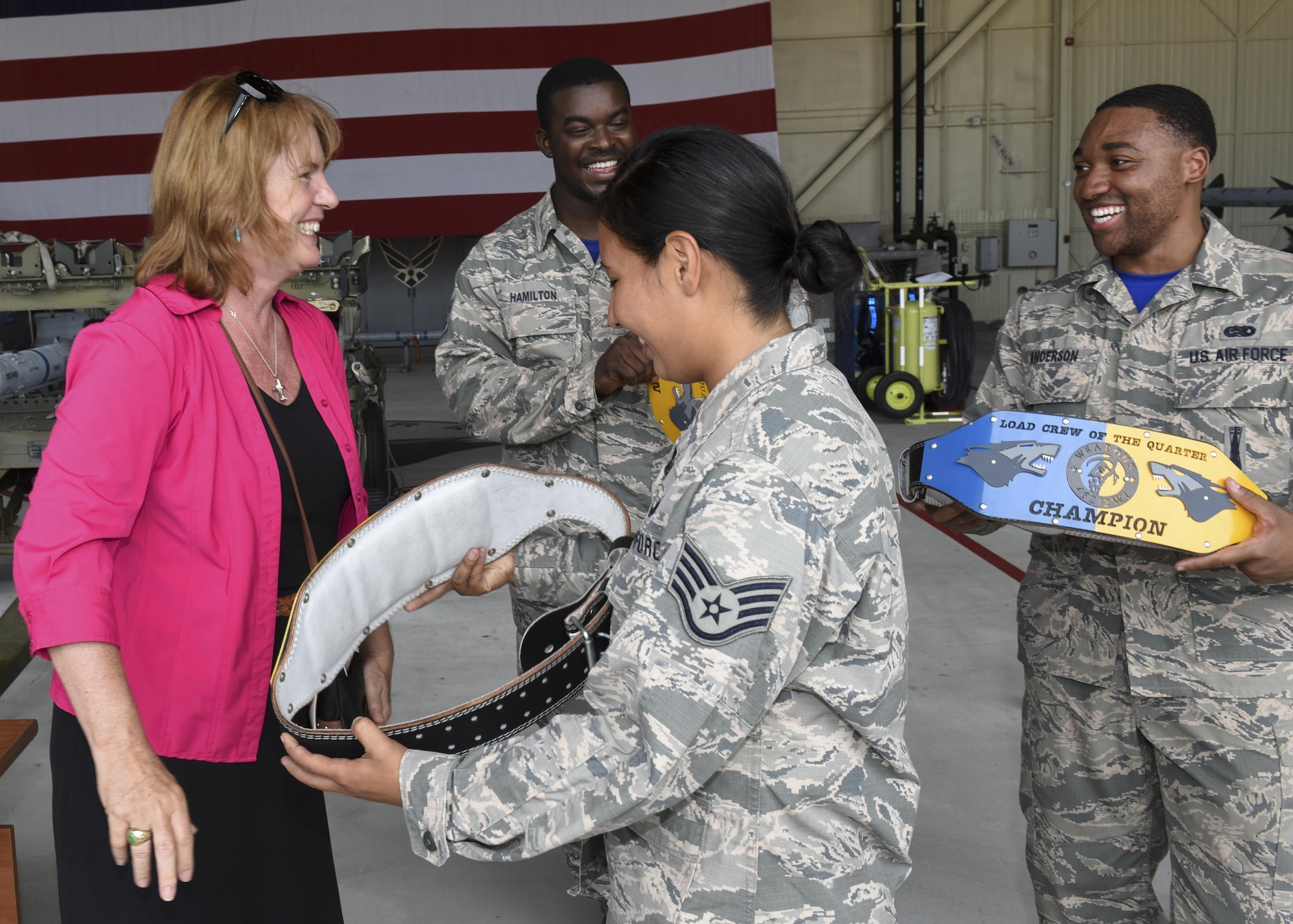 Christina Olds, daughter of Brig. Gen. Robin Olds, presents awards to U.S. Air Force Airmen assigned to the 35th aircraft maintenance unit for winning the quarterly weapons load competition at Kunsan Air Base, Republic of Korea, July 14, 2017. Kunsan held the competition in conjunction with Ms. Olds’ visit to commemorate her father, Robin Olds, 95th birthday. (U.S. Air Force photo by Senior Airman Michael Hunsaker/Released)