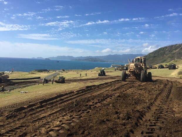 Pfc. Miles Perron from the 561st Engineer Construction Company, 84th Engineer Battalion, 130th Engineer Brigade, 8th Theater Sustainment Command operates the 120M Grader and manages the material excavated from the Range 5 Trench Construction Project on Marine Corps Base Hawaii. The recently completed live-fire trench warfare system facility will provide increased readiness for land forces across Hawaii.