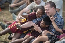 U.S. Air Force Maj. Scott Stewart, a pediatrician with the 673rd Medical Group at Joint Base Elmendorf-Richardson, Alaska, cuddles close with Fijian students while taking a selfie together during a sports day community engagement activity at the Lautoka School for Special Education in Lautoka, Fiji, July 14, 2017. Stewart is part of this year’s Pacific Angel where he and more than 50 U.S. service members will join multilateral international participants from across the Indo-Asia-Pacific working together to assist the local community and improve capabilities among each other as one team. (U.S. Air Force photo by Tech. Sgt. Benjamin W. Stratton)