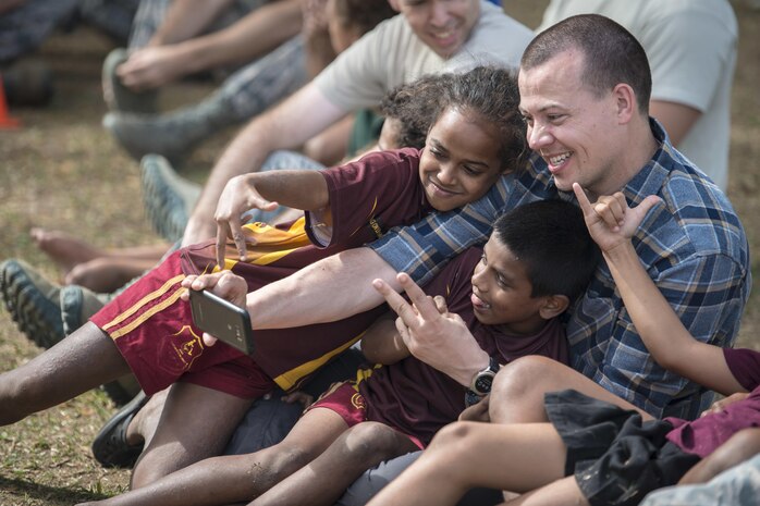 U.S. Air Force Maj. Scott Stewart, a pediatrician with the 673rd Medical Group at Joint Base Elmendorf-Richardson, Alaska, cuddles close with Fijian students while taking a selfie together during a sports day community engagement activity at the Lautoka School for Special Education in Lautoka, Fiji, July 14, 2017. Stewart is part of this year’s Pacific Angel where he and more than 50 U.S. service members will join multilateral international participants from across the Indo-Asia-Pacific working together to assist the local community and improve capabilities among each other as one team. (U.S. Air Force photo by Tech. Sgt. Benjamin W. Stratton)