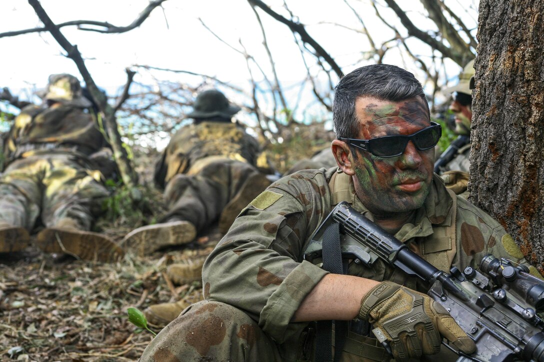 Army Sgt. Anthony Coppola guards an observation post at Shoalwater Bay, Queensland, Australia, July 14, 2017, during exercise Talisman Saber with Australian and New Zealand forces. Coppola is an assistant team leader assigned to the New York Army National Guard's 2nd Squadron, 101st Cavalry Regiment. He wore a mix of Australian and American uniform items because of the unit's role as an opposing force. Army National Guard photo by Sgt. Alexander Rector