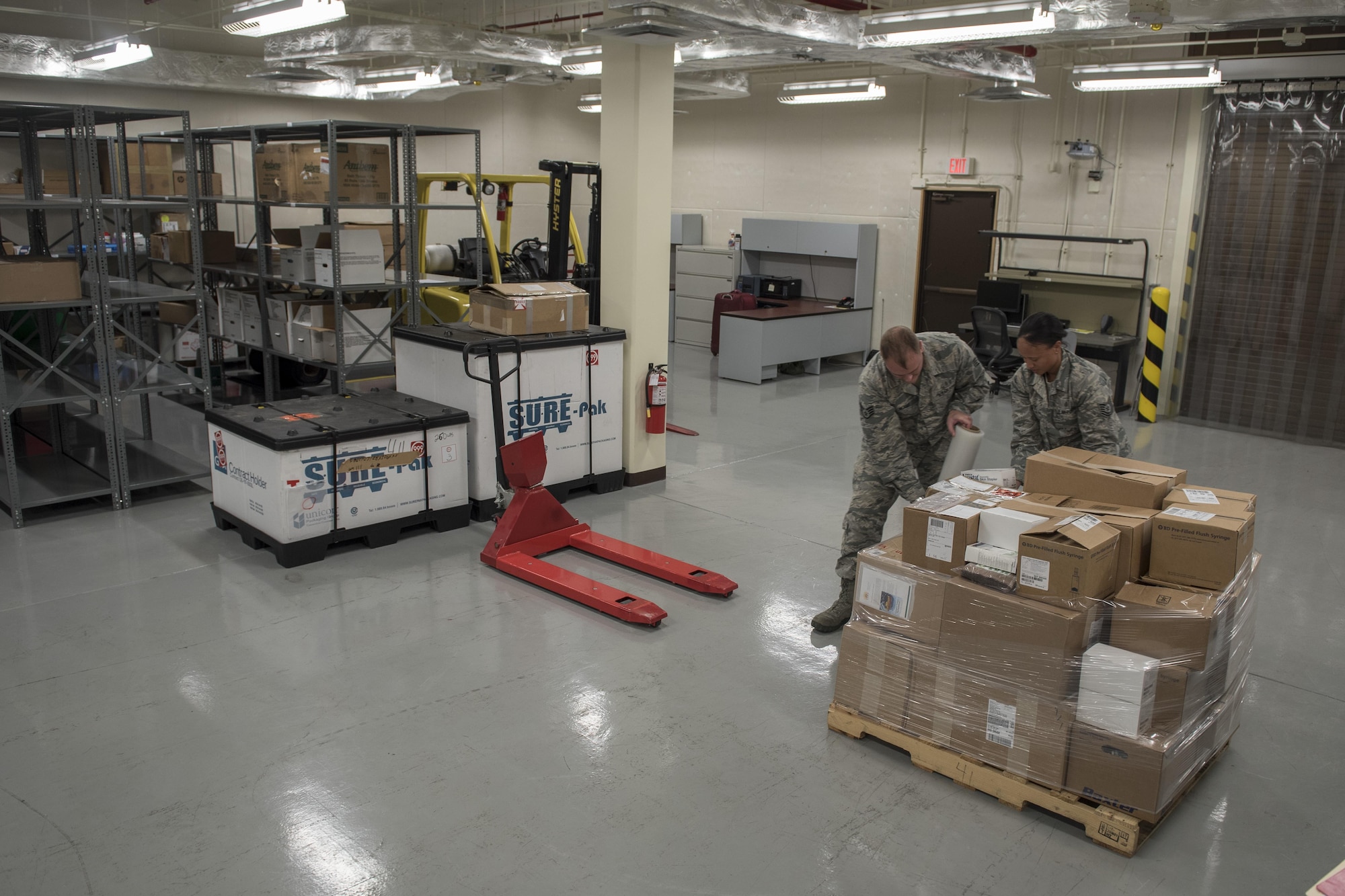 U.S. Air Force Tech. Sgt. Danyelle Saboy and Staff Sgt. Jared Bland, 18th Medical Support Squadron medical logistics technicians, pack medical supplies for their customers during a medical material distribution exercise July 13, 2017, at Kadena Air Base, Japan. The Theater Lead Agent for Medical Material – Pacific hosted the exercise, which serves as the central node for providing medical supplies and equipment to all deployed forces within PACOM, with the exception of the Korean peninsula.(U.S. Air Force photo by Senior Airman John Linzmeier)